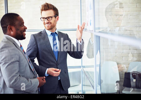Two colleagues discussing business documents in office Stock Photo