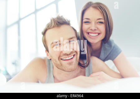 Young man and woman looking at camera with smiles Stock Photo