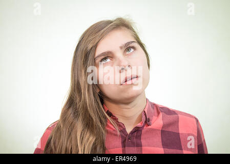 Girl lookes disappointed and is rolling her eyes like a teenager would do when is angry. Stock Photo