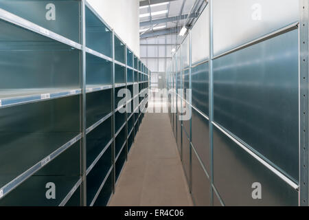 Newly installed empty warehouse storage shelves and racks in a generic warehouse Stock Photo