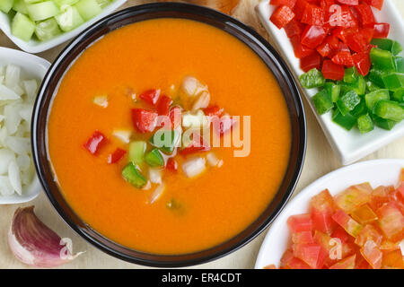 Spanish gazpacho and ingredients on bowls Stock Photo