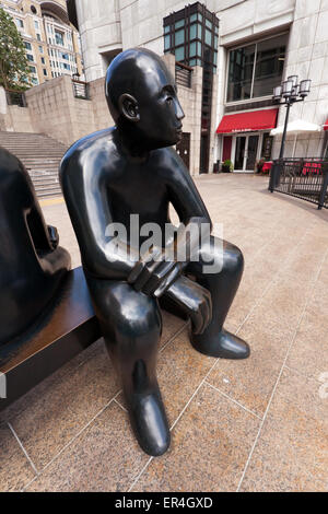 Close-up view of a bronze statue of a two men on a bench, by Giles Penny, at Canary Wharf, Isle of Dogs, London. Stock Photo
