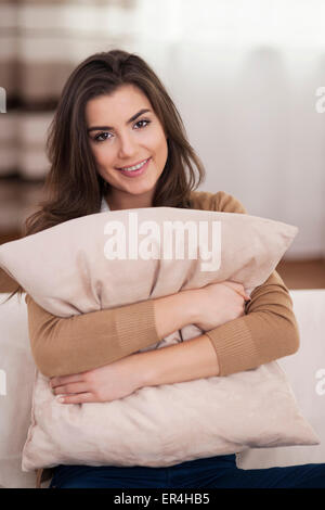 Beautiful woman hugging a soft pillow Stock Photo