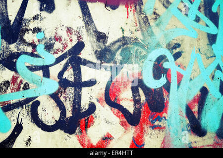 Abstract colorful graffiti patterns over old urban concrete wall, vintage tonal photo filter effect, retro style Stock Photo