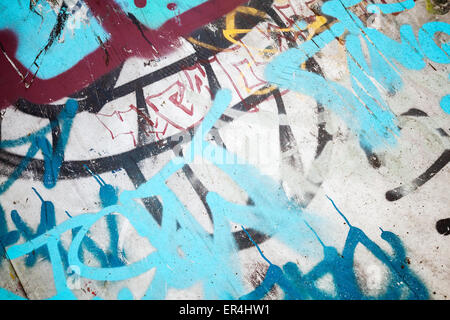 Abstract colorful graffiti fragment over old urban concrete wall, vintage tonal photo filter effect, retro style Stock Photo