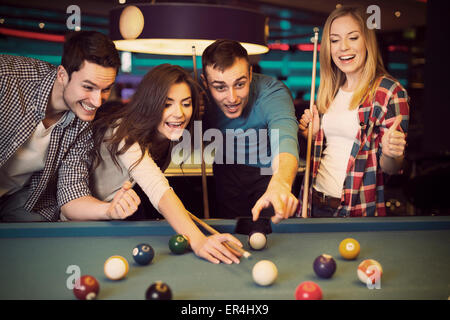 Premium Photo  Friends playing pool at billiard club and shooting