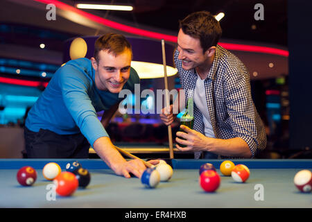 Premium Photo  Friends playing pool at billiard club and shooting