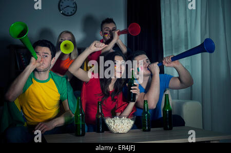 Friends watching football together Stock Photo