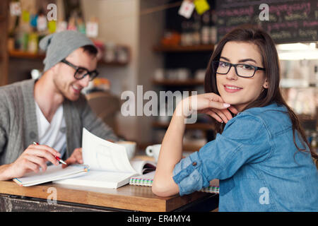 Stylish woman studying with her friend at cafe. Krakow, Poland Stock Photo