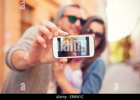 Young couple taking selfie in the city. Krakow, Poland Stock Photo
