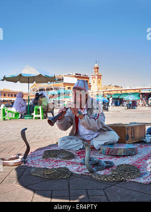 Snake Charmer in the 'Djeema el fnaa'  - The very busy Marrakech market square Stock Photo