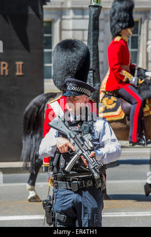 London, UK. 27th May, 2015. Security is tight with armed police guarding the armed soldiers. The Queen, Prince Charles and her crown pass down Whitehall, in carriages of state,  on their return from the State Opening of Parliament.Whitehall, London, UK, 27 May 2015. Credit:  Guy Bell/Alamy Live News Stock Photo