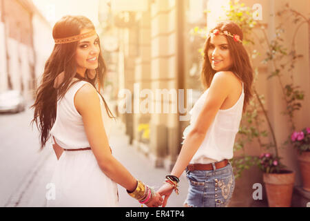 Female boho girls walking in the city. Krakow, Poland Stock Photo