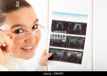 Smiling Doctor checking thyroid ultrasound photograph Stock Photo