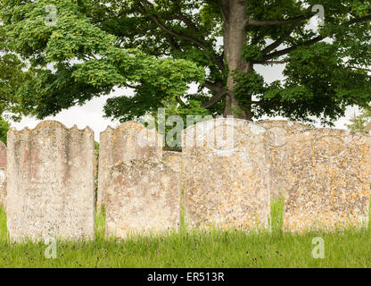 Tombstones in the graveyard at christian church of St Michael and All Angels, Wadenhoe, England. Stock Photo