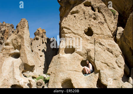 Girl Climbing in Hole in the Wall Canyon, Mojave National Preserve located in the Mojave Desert of California, USA. Stock Photo