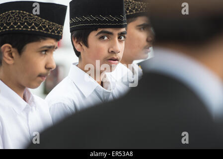Hanau, Germany. 27th May, 2015. Boys attend the opening of the new Bait-ul-Wahid mosque of the Ahmadiyya Muslim Jamad denomination in Hanau, Germany, 27 May 2015. The mosque has two 12-metres tall minarets and offers space for up to 500 people. Photo: BORIS ROESSLER/dpa/Alamy Live News Stock Photo