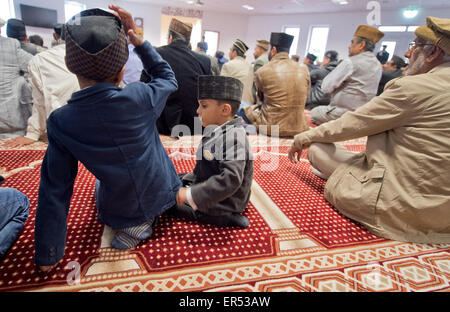 Hanau, Germany. 27th May, 2015. Young boys wait for the start of the prayers during the opening of the new Bait-ul-Wahid mosque of the Ahmadiyya Muslim Jamad denomination in Hanau, Germany, 27 May 2015. The mosque has two 12-metres tall minarets and offers space for up to 500 people. Photo: BORIS ROESSLER/dpa/Alamy Live News Stock Photo