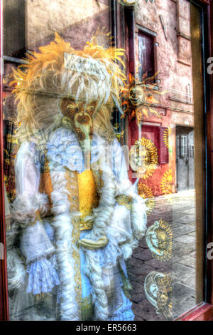 Street reflections in shop window selling Venetian Masks and costumes, Venice, Italy Stock Photo