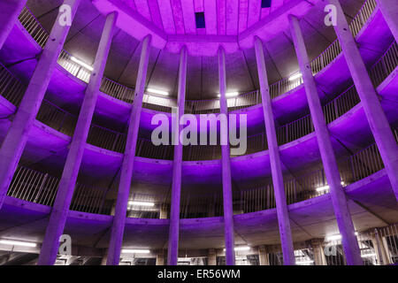 Spiral parking garage  Ossenmarkt in Groningen, The Netherlands. Purple color coming from the ever changing lighting system. Stock Photo