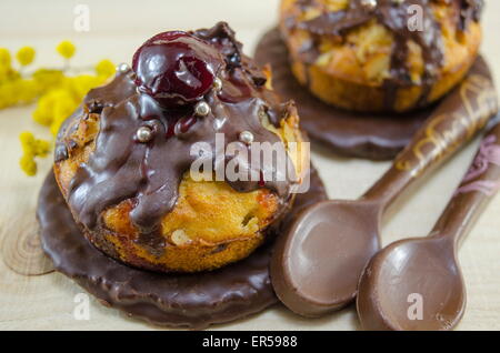 Homemade donuts glazed with chocolate with a cherry on top Stock Photo