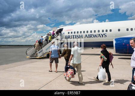 Passengers boarding British Airways (Comair) Boeing 737 at Hosea Kutako International Airport, Windhoek, Republic of Namibia Stock Photo