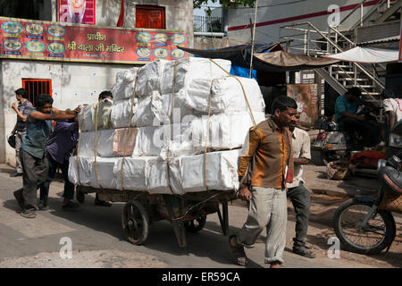 India, Old Delhi. Typical street hand wagon loaded with heavy cargo. Stock Photo