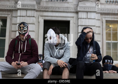 London, UK. 27th May, 2015. Demonstrators sit on a wall on Whitehall in central London during an evening of protest against public sector spending cuts imposed by Britain's Conservative Party in the years since the party, known also as the Tories, came to power in 2010. The evening's protests were held on the day of the State Opening of Parliament, with spending cuts set to continue—and, many fear, deepen—following the Conservatives' surprise majority win in Britain's recent general election. Credit:  David Cliff/Alamy Live News