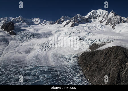 Fox Glacier and Mount Tasman are seen from an aerial perspective along New Zealand's West Coast Stock Photo
