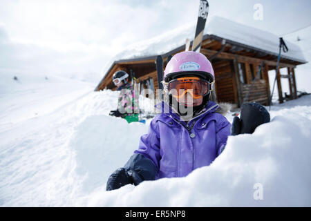 Two children in snow in front of a hut, ski resort Ladurns, Gossensass, South Tyrol, Italy Stock Photo