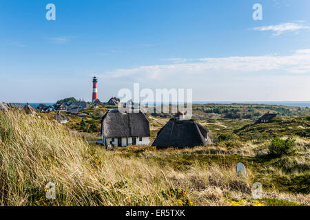 Lighthouse and thatched-roof houses in the dunes, Hoernum, Sylt, Schleswig-Holstein, Germany Stock Photo