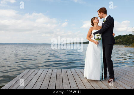 bridal couple is standing on jetty, Starnberger See, Bavaria, Germany Stock Photo
