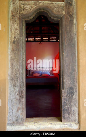 View through the door in a rustic room of the Eco-Resort The Samadhi Center, resort in the mountains near Kandy, Sri Lanka