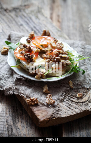 Homemade bagel filled with goat cheese and tomato Stock Photo