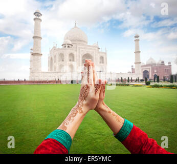 Woman hands with henna painting in Namaste gesture near Taj Mahal in Agra, Uttar Pradesh, India Stock Photo