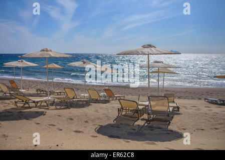 Sunbeds and umbrellas on the beach of Kalamaki in southern Crete Stock Photo