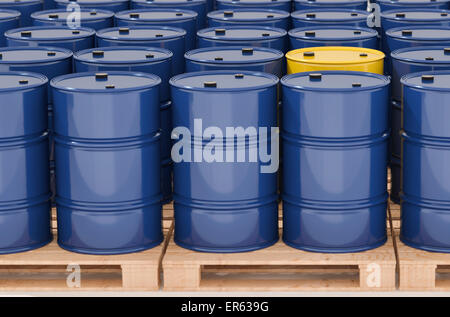 Metal barrels on pallets, many blue and a single yellow Stock Photo