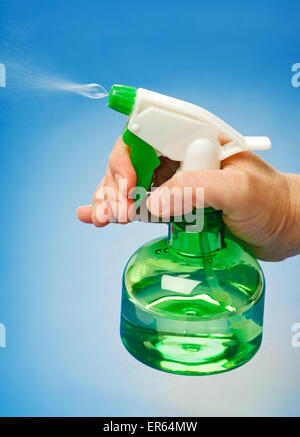 Water being sprayed from green bottle Stock Photo