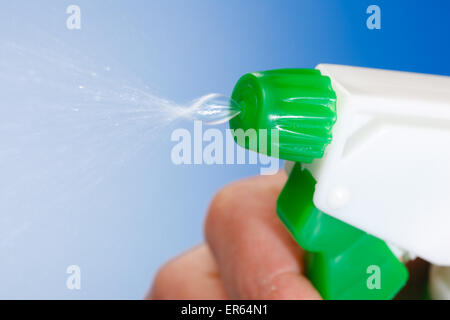 Macro of water being sprayed from green bottle Stock Photo
