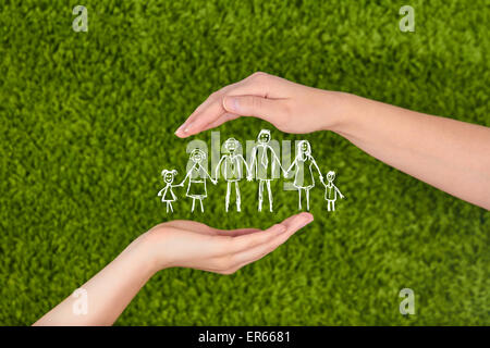 Two Woman's open hands making a protection gesture  isolated on green background.Family life insurance, protecting family Stock Photo