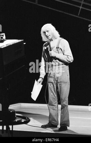 Disc Jockey Jimmy Saville pictured with Liverpool pop group The Beatles at Finsbury Park Astoria in London.The Beatles and Saville appeared together on the first ever Top Of The Pops programme on