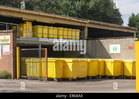 Bright yellow bulk clinical waste bins next to the waste incinerator plant at the Royal Bolton Hospital, Lancashire. Stock Photo