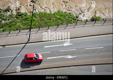 The view from above of a red hatchback preparing to make a right turn. Stock Photo