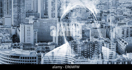 Double exposure conceptual collage with a man in a hood over big modern cityscape background Stock Photo