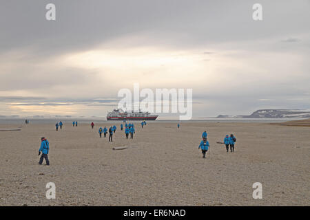 Passengers on Torellneset making their way back to MV Fram moored off shore in Hinlopenstretet, south Nordaustlandet, Svalbard. Stock Photo