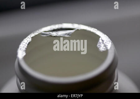 opened foil sealed tamper proof top on a bottle of pills Stock Photo