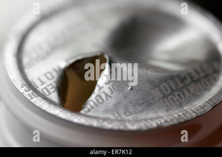 broken tampered with foil sealed tamper proof top on a bottle of pills Stock Photo