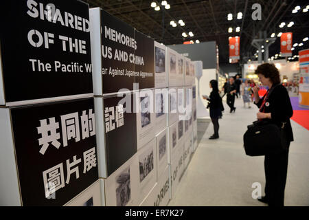 New York, USA. 28th May, 2015. Visitors look at photos at 'Shared Memories of the US and China' photo exhibition during the BookExpo America (BEA) 2015 in New York, the United States, on May 28, 2015. A book launch and a photo exhibition of the 'Shared Memories of the US and China' in fighting side by side in the Second World War were held on Thursday as part of the ongoing BookExpo America (BEA) 2015. Credit:  Wang Lei/Xinhua/Alamy Live News Stock Photo