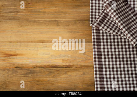 Brown checkered Tablecloth on  wooden background. Stock Photo