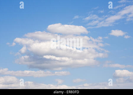 Cumulus clouds against a blue sky. Stock Photo